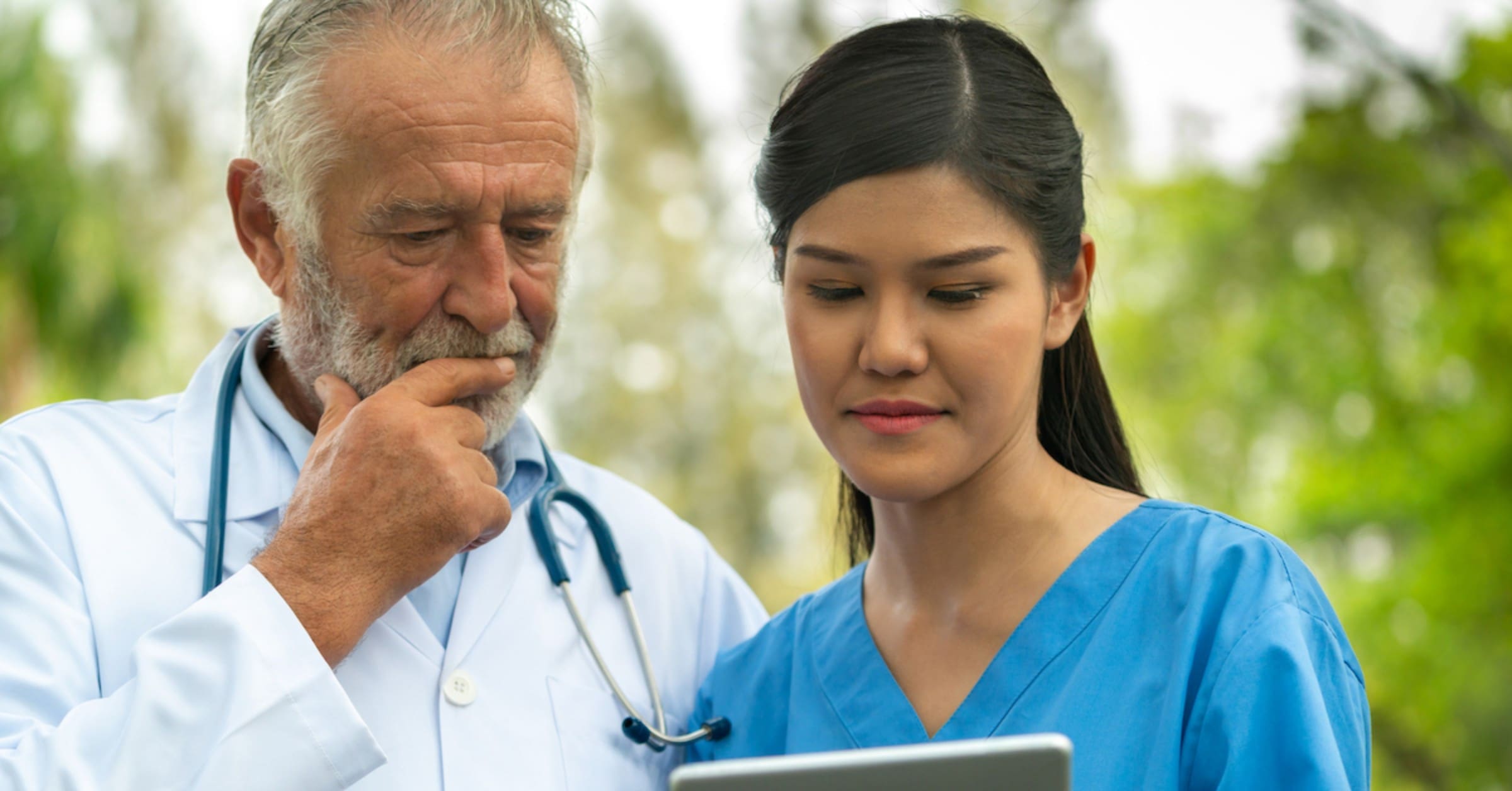 doctor and nurse looking at a tablet